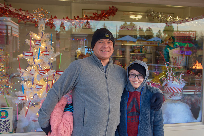 Omar and Blake Chyou visited Camp Christmas for the first time this year, with Alice Chyou hiding behind her father.